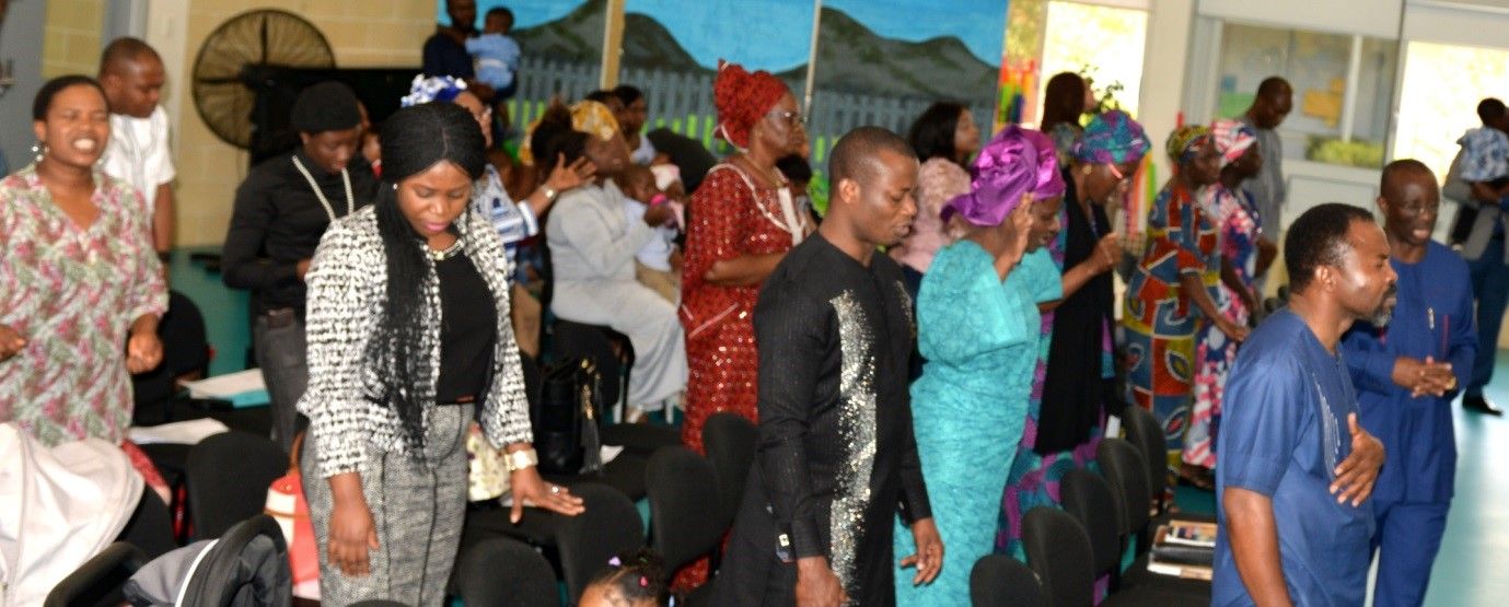 Members of the church greeting one another warmly after a service