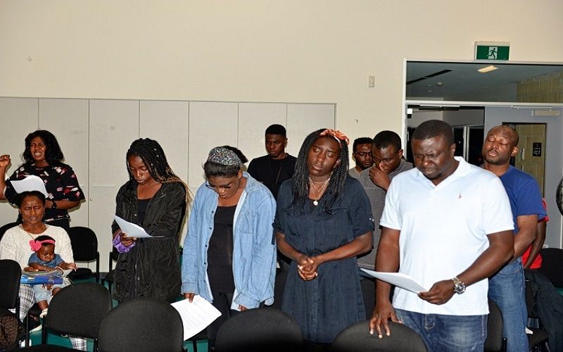 Church members standing together in prayer