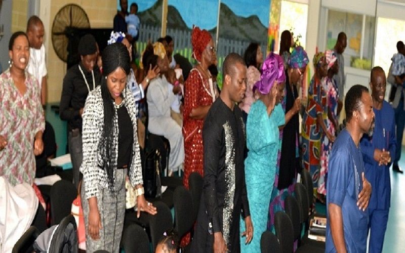 Women of the church greeting one another in colourful dress